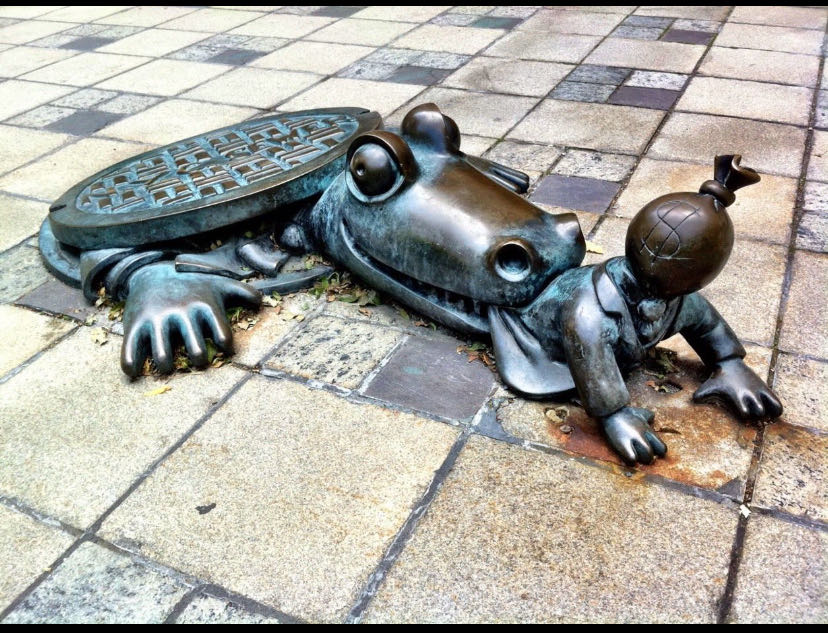 A reptilian crocodile in a suit with human hands, dragging a